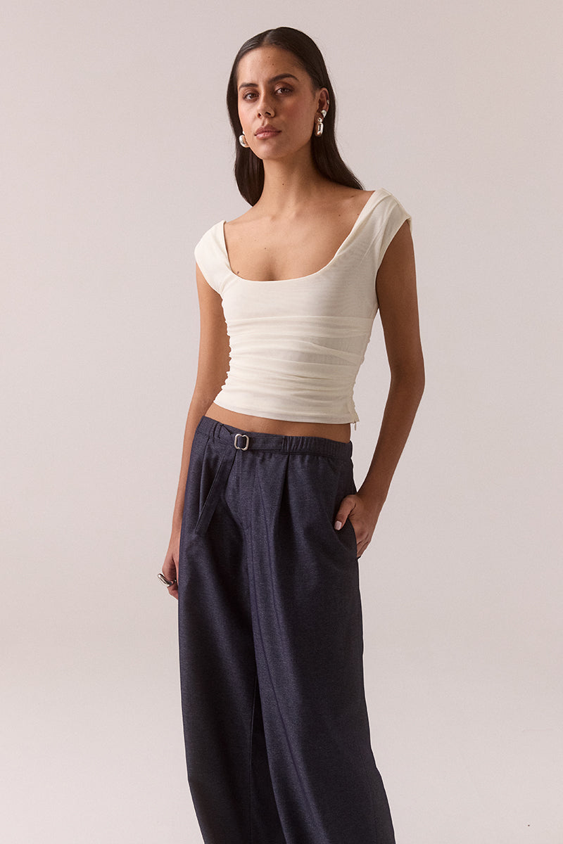 Sleeveless stretch mesh top with wide scoop neckline and fitted silhouette