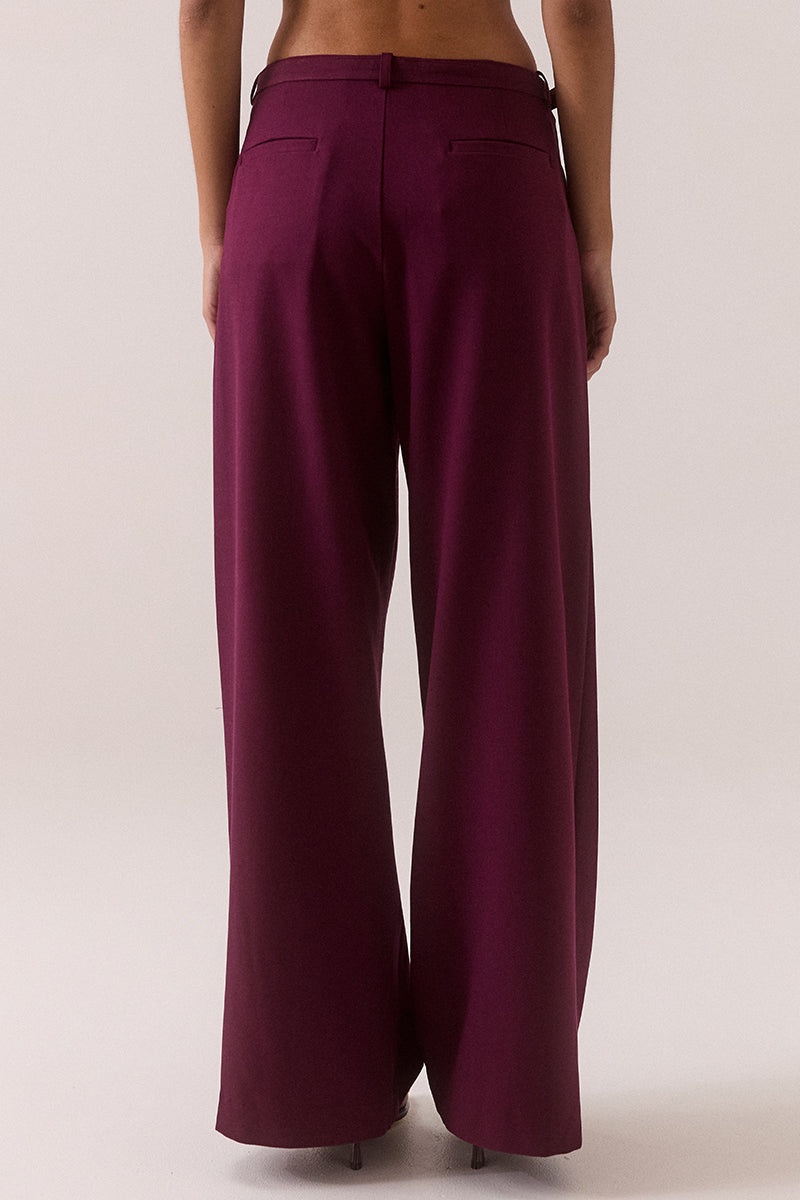 Mid rise wide-leg stretch rayon blend pants with front pleats, removable belt with silver buckle, angled front pockets and back welt pockets.