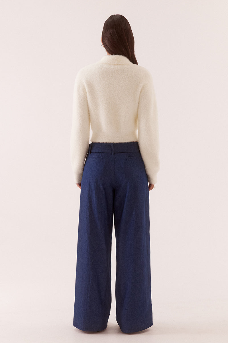 Model wearing a fluffy knit cardigan with collar, short buttoned front, long sleeves, dropped shoulders and fitted ribbed hem and cuffs.