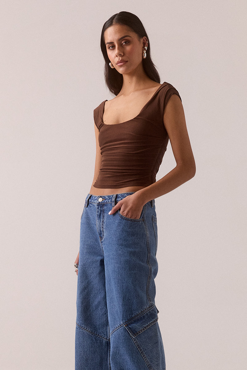 Sleeveless stretch mesh top with wide scoop neckline and fitted silhouette