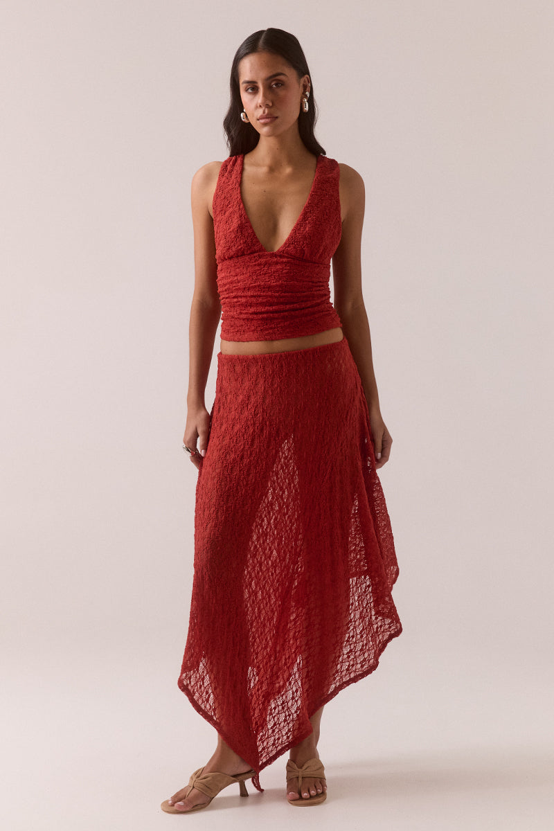 Mid rise stretch lace midi skirt with double layer construction, removable mesh lining, asymmetric hem and circle cut godet panel at side, worn by model in size 8.