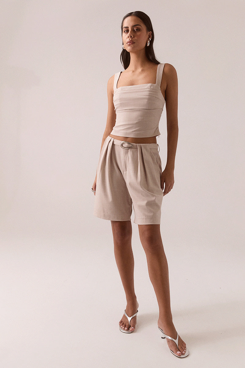 Women’s fitted top in stretchy rayon blend with balconette neckline, layered tuck details, wide adjustable straps, deep underbust tuck, and back zipper closure.