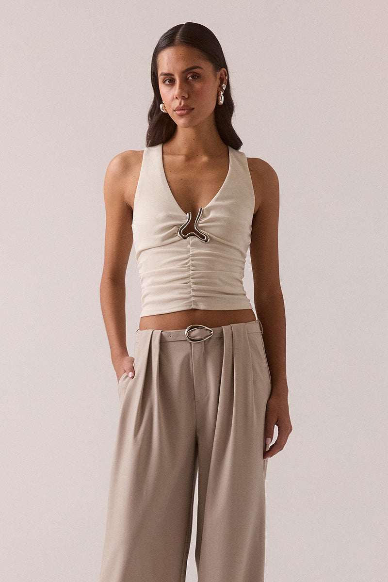 Fitted sleeveless V-neck top in stretchy fabric with silver chest hardware, gathered waist, racer back and pull-on design, fully lined, worn by model in size 8.
